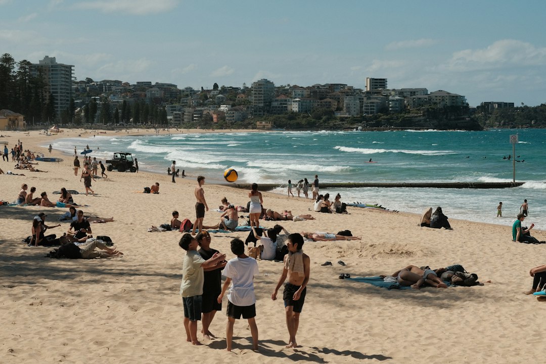 Family walks along the sand at one of Sydney's northern beaches