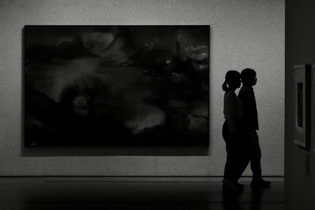 Couple weighing gallery membership value inside a Sydney exhibition