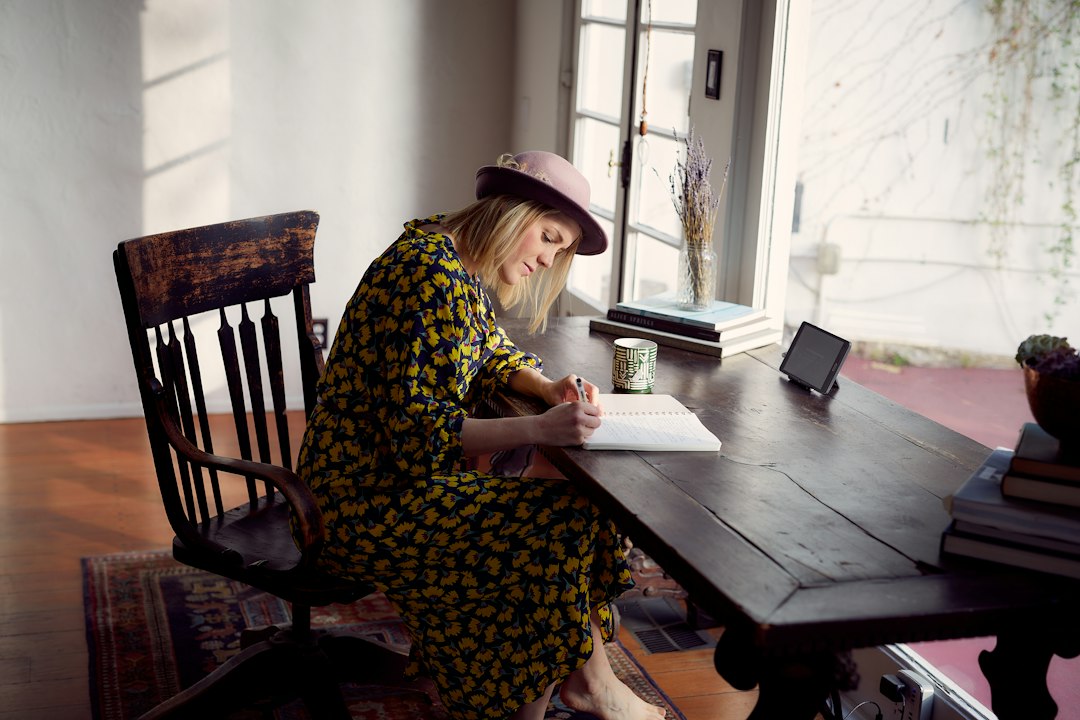 Woman planning a grocery list to cut food waste in a Sydney kitchen